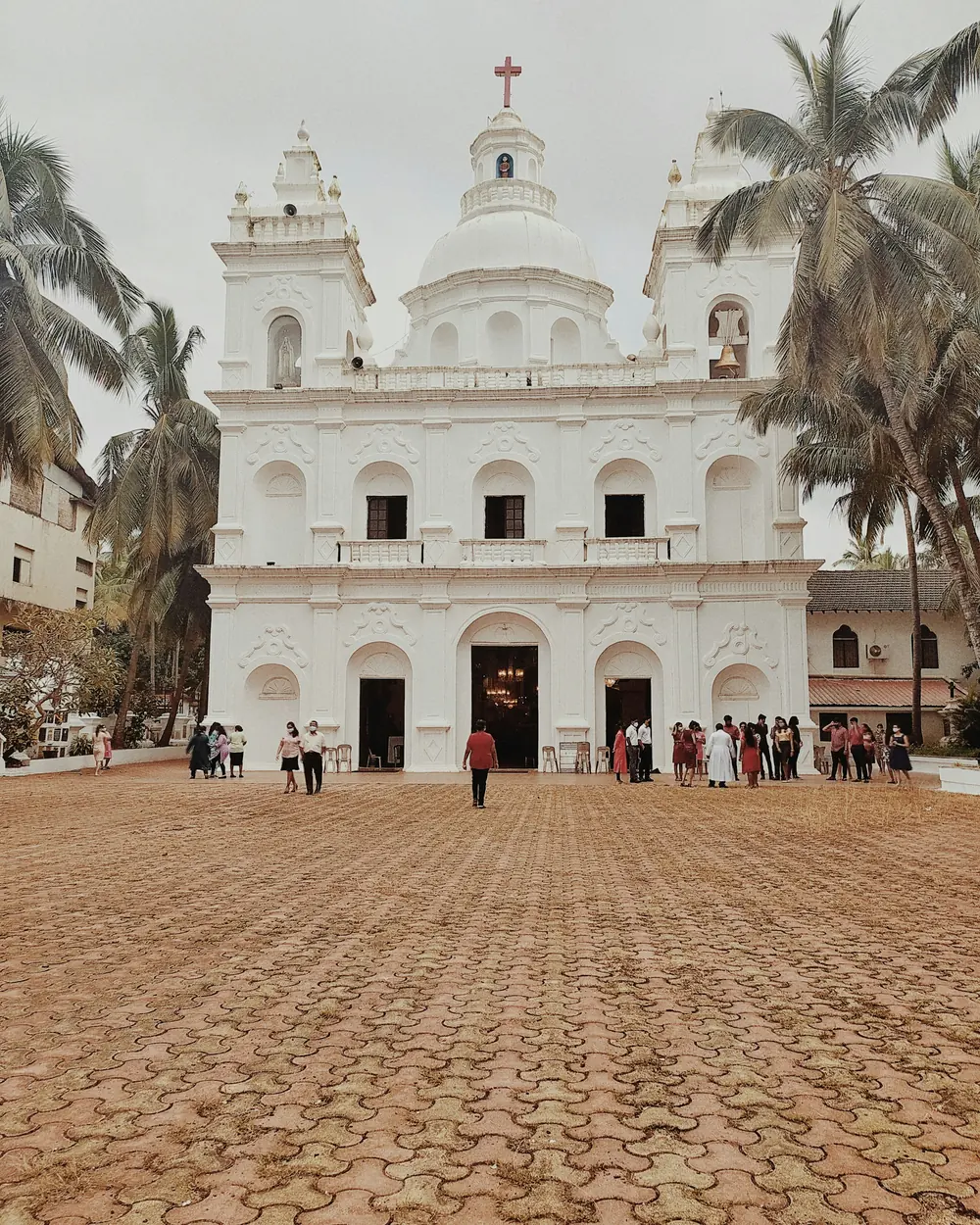 a large white building with a cross on top