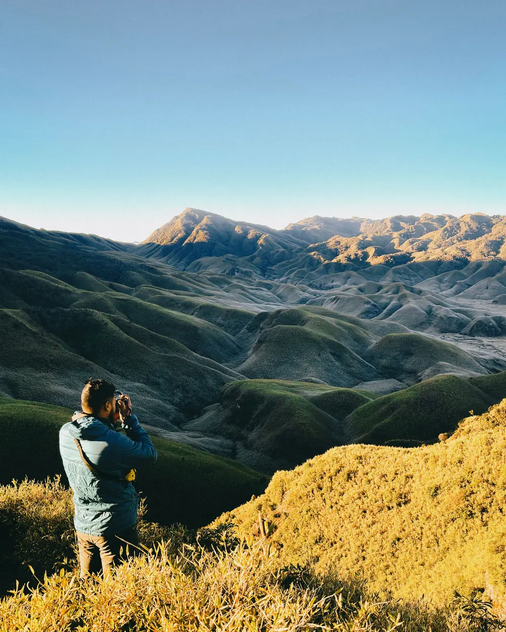 A photographer in Nagaland captures breathtaking sunrise over scenic green mountains