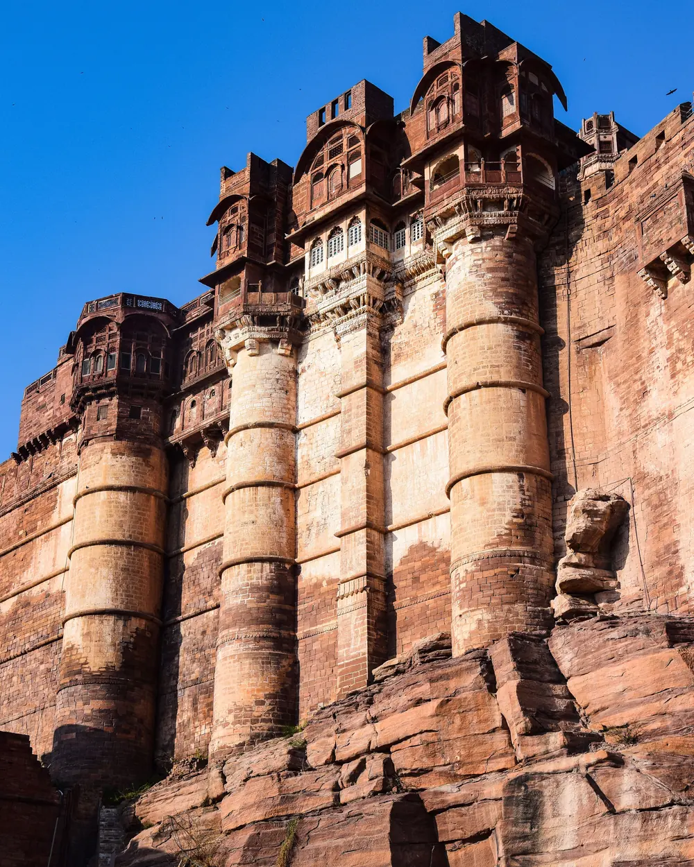 Explore the majestic architecture of the historic Mehrangarh Fort in Jodhpur, India under a clear blue sky